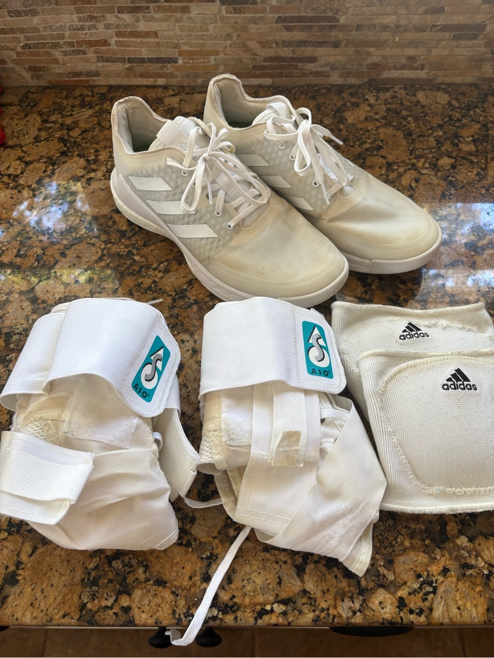 adidas White womens volleyball shoes. Ankle braces and knee pads